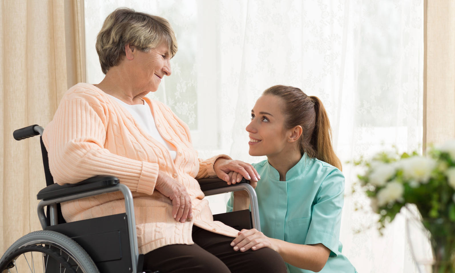 caregiver with woman wheelchair