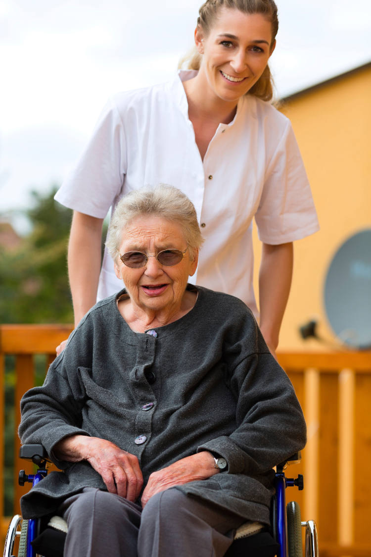 female caregiver senior woman walker