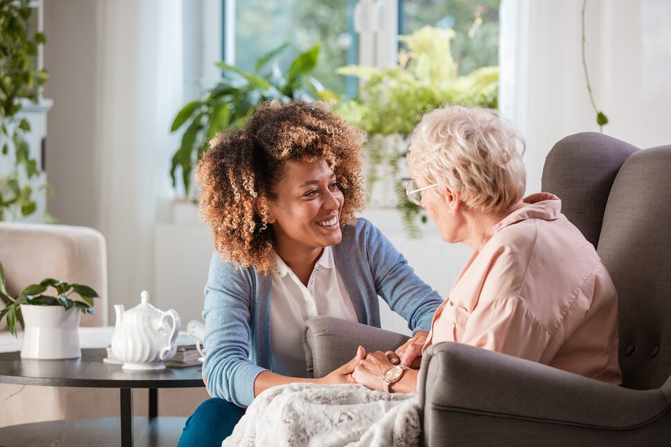 Personal Care Aide assisting elderly female client