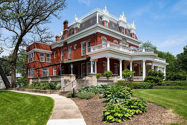 Ellwood_House_DeKalb_Illinois_2022-6682 female caregiver helping elderly woman on stairs