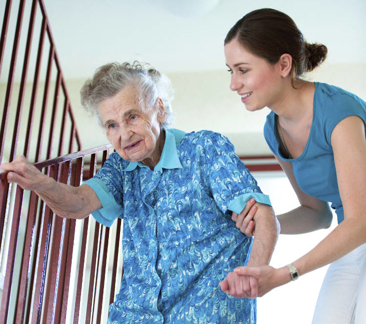 female-caregiver-helping-elderly-woman-on-stairs-halved female caregiver helping elderly woman on stairs